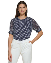 Blouse à pois pour femme avec manches transparentes bouffantes et fermeture par bouton au dos