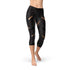 Leggings capri femmes noirs avec rayures sportives, confort et performance, tissu extensible et respirant.