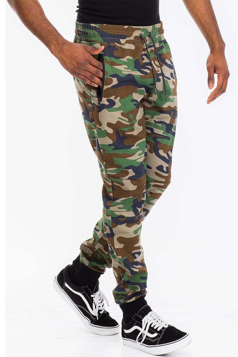 Pantalon sweat en coton chiné avec taille et chevilles élastiques, cordon de serrage et poches zippées.